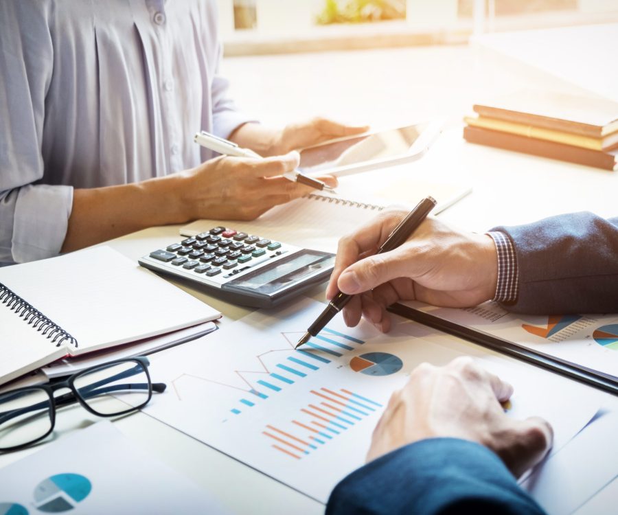 business man financial inspector and secretary making report, calculating or checking balance. Internal Revenue Service inspector checking document. Audit concept