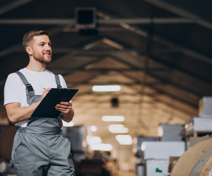 Young handsome man working at a factory